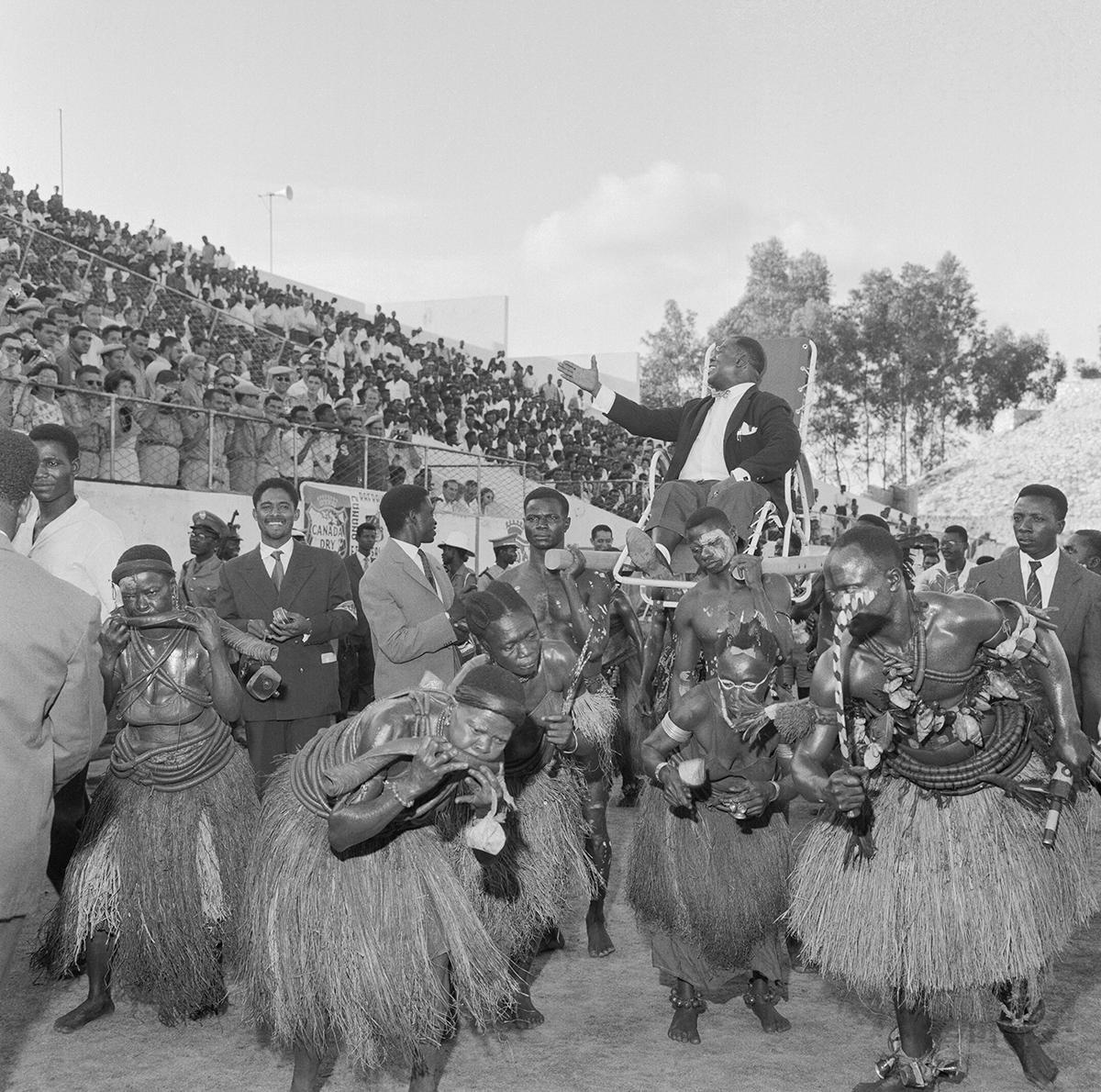 Armstrong is carried in triumph to the Baudouin stadium in Brazzaville during his Africa Tour
