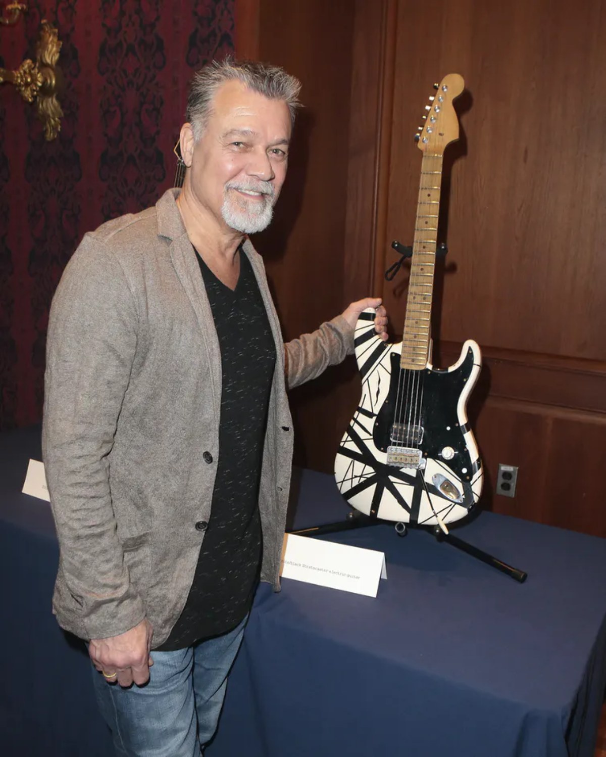 Van Halen poses with his "Frankenstein guitar" on display at the Smithsonian's National Museum of American History in 2015