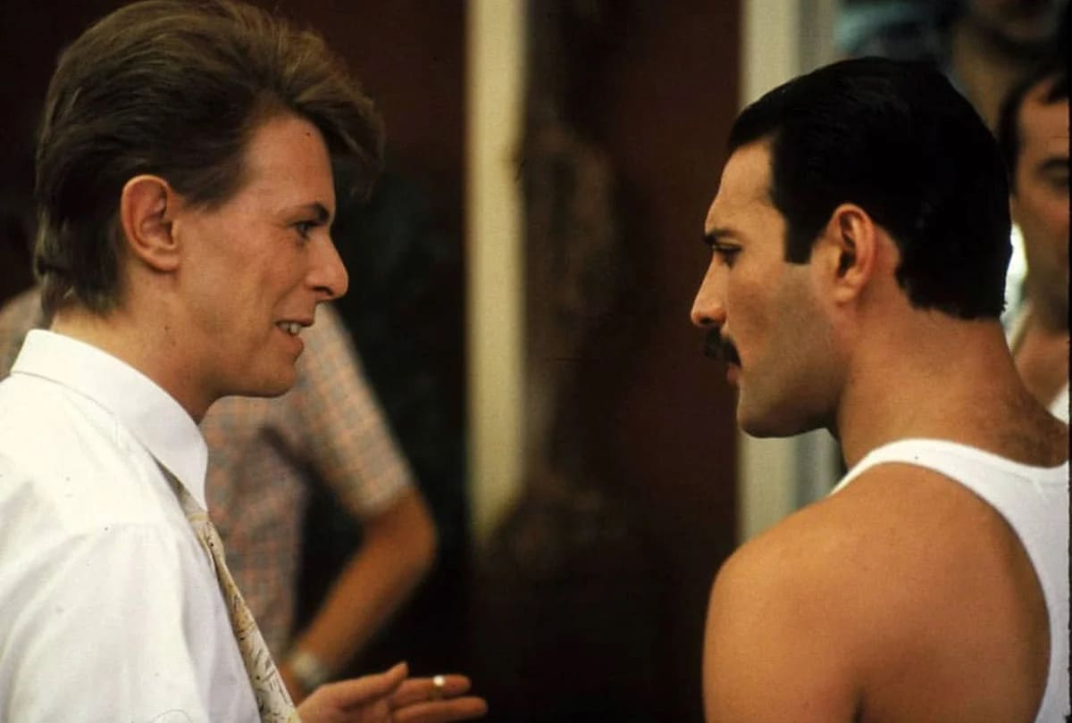 David Bowie and Freddie Mercury chatting backstage