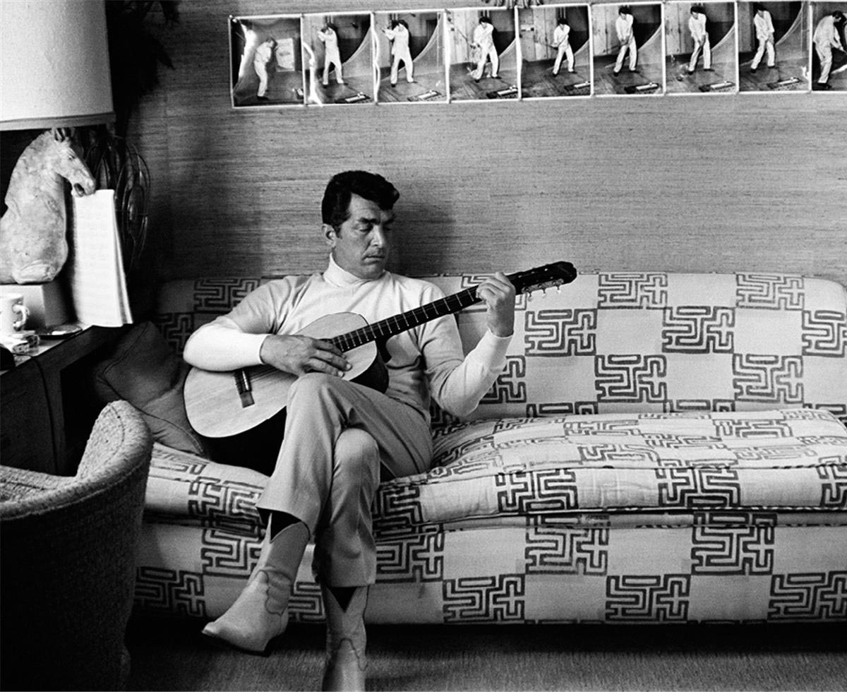 Dean Martin plays guitar at home
