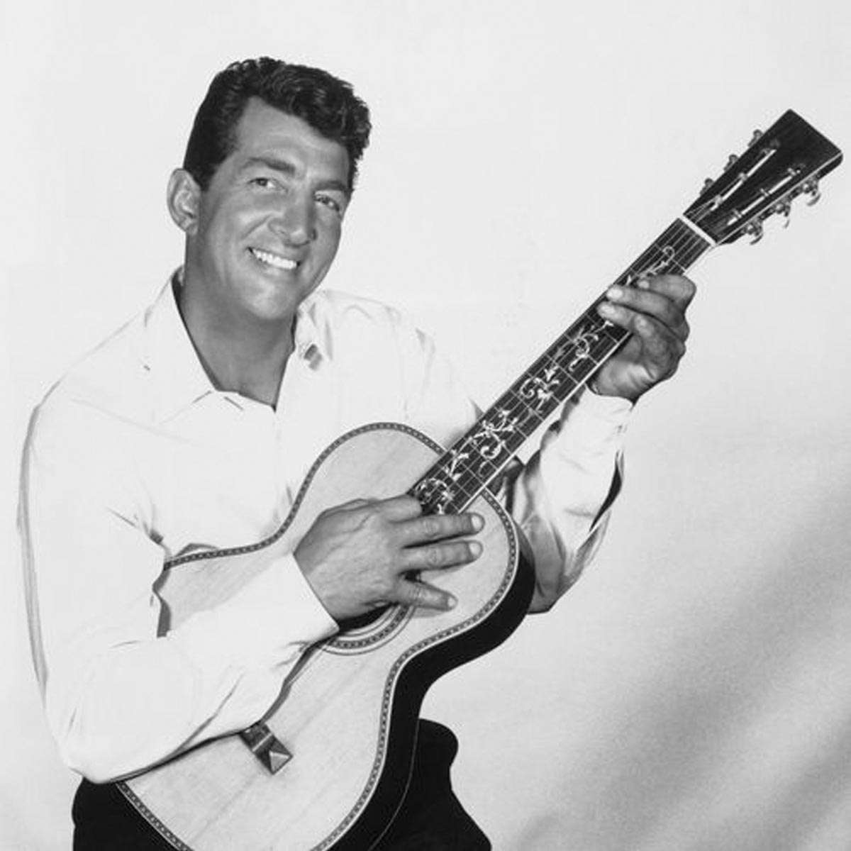 Dean Martin posing with a guitar