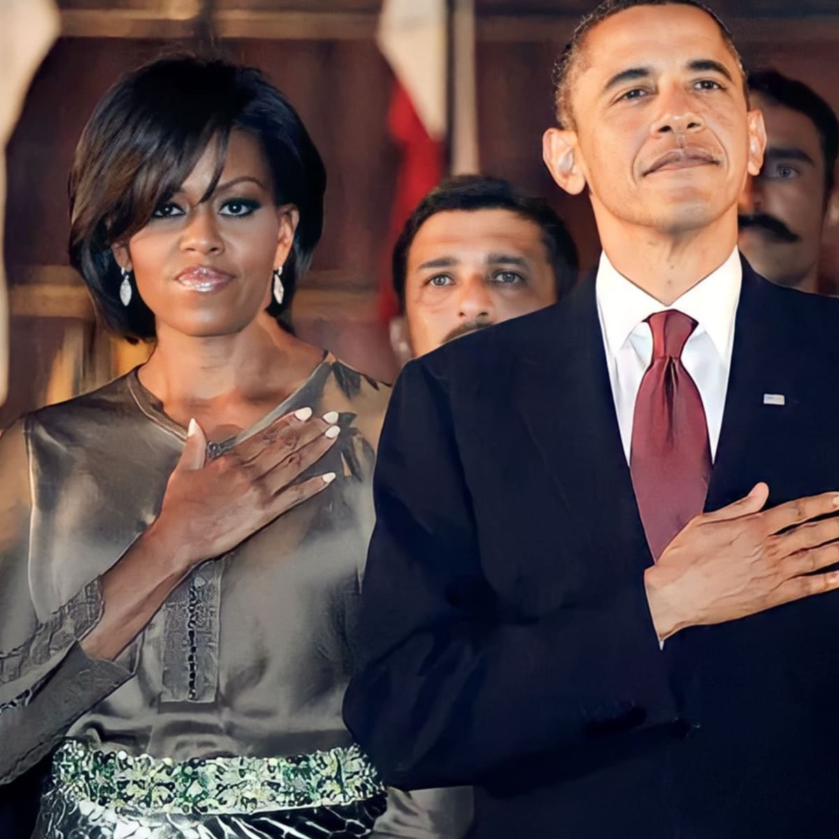 Barack Obama and his wife listen to the U.S. anthem